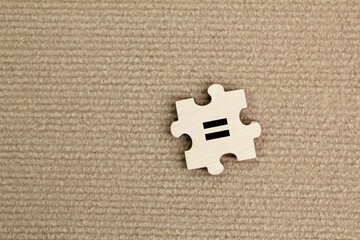 wooden puzzle with an equivalent icon. Symbol, equal, equal or same concept.