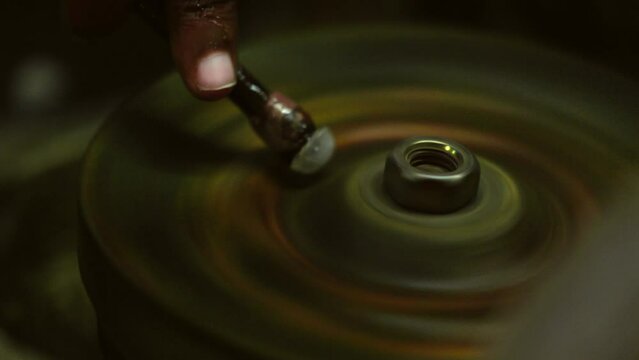 Local jeweler Grinding Moonstones in Sri Lanka. A girl grinds a moonstone in a semi-precious stone mining and processing plant. Slow motion 120 fps, ProRes 422, 10 bit video