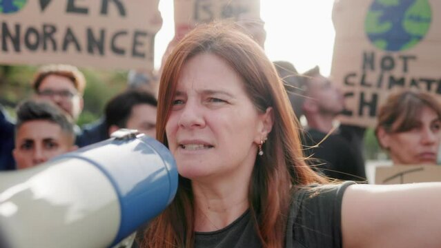 Earth day activist: Group of people protests for climate change in the city - Global warming demonstration concept
