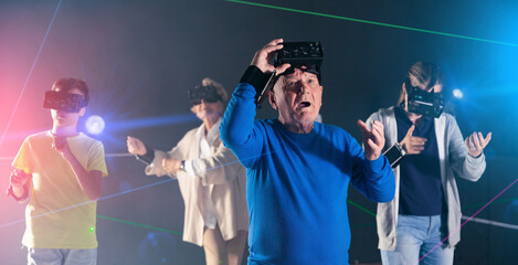 Grandfather amazed by playing VR games with family and taking his headset off.