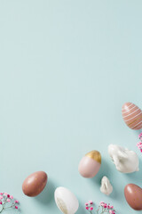 Obraz na płótnie Canvas Happy Easter poster design. Stylish Easter eggs, decorative bunnies, flowers on pastel blue background.