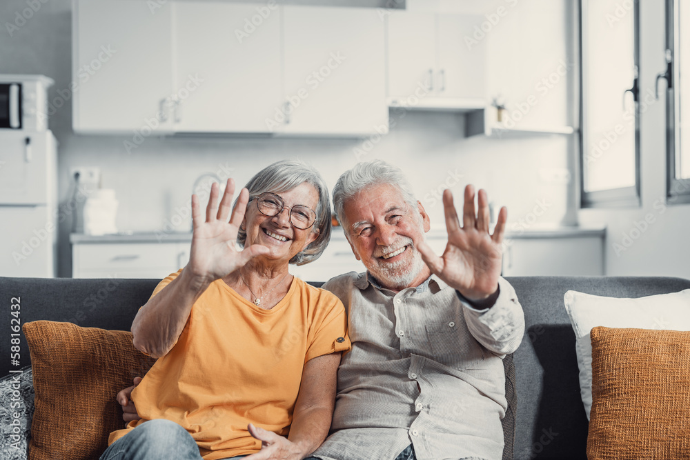 Canvas Prints Sixty years couple, elderly parents communicates with grown up children using modern technologies makes video call, wave hands gesture of hello or goodbye sign, older generation and internet concept.