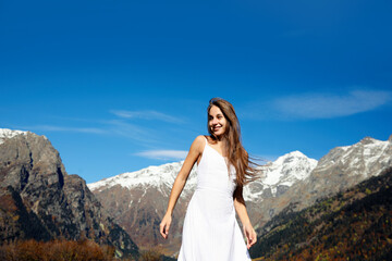 Naklejka na ściany i meble Young woman walking in beautiful mountains on sunny day