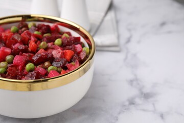 Delicious vinaigrette salad on white marble table, closeup. Space for text