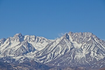 Fototapeta na wymiar Large amounts of snow top the Sierra Nevada Mountains viewed from California's Eastern Sierra region
