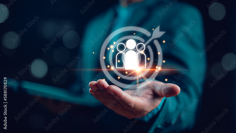 Poster Businessman showing virtual human icon on dartboard with arrow for business CRM or Customer Relation Management and customer focus target group concept, social media. Digital marketing online.