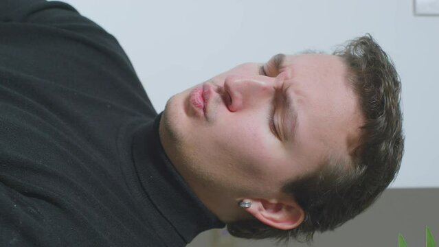 Man black turtleneck makes different facial expressions grimaces emotions feelings sends air kiss fake smile. Actor rehearsing role mask. Training emotions feigning bluff. Pickup flirting skills