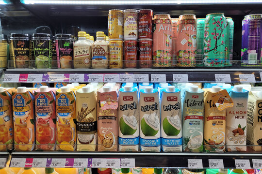 PENANG, MALAYSIA - 2 APR 2023: Various brand soft drink, coffee and fruits beverages on the refrigerator shelf in Village Grocer. Village Grocer is the coolest fresh premium supermarket in Malaysia.