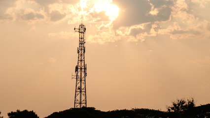 A signal pole that blocks the sunset.