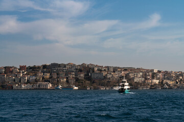 Fototapeta premium View of the Uskyudar district on the Asian side of the Bosphorus Strait of Istanbul province on a sunny day, Istanbul, Turkey