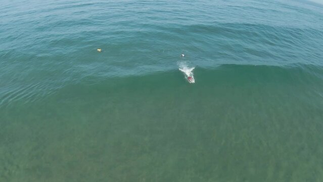 Bodyboarder kicks and prepares to take off on epic ocean wave ride