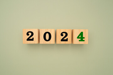 Wooden cubes with the letters 2024 on a green background