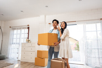 Asian young happy new marriage couple moving to new house together. 