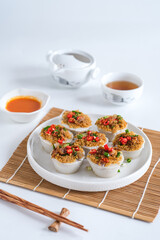 kue talam ebi or kiam kue made from rice flour, coconut milk with toppin dried shrimp, fried onion, chili slice and onion leaf. selective focus