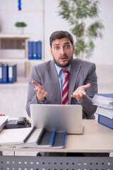 Young male employee working in the office