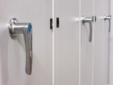 Close up photo of door handle with key on low voltage switchboard.