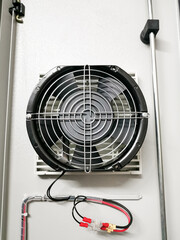 Selective focus image of exhaust fan in electrical panel.