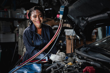 Mechanics inspect and check the refrigerant and fill the car air conditioner in the garage.