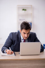 Young male employee working in the office