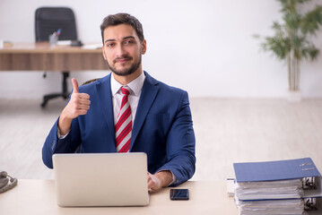 Young male employee working in the office