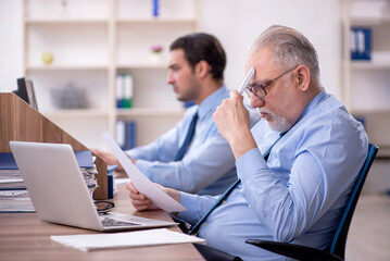 Fototapeta premium Two male colleagues working in the office