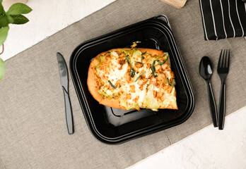 Pizza in the to-go or takeaway box for online orders and food delivery.