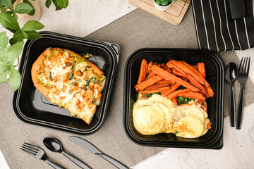 Take away or to-go food box of pizza and egg benedict for delivery and online order. American traditional food.
