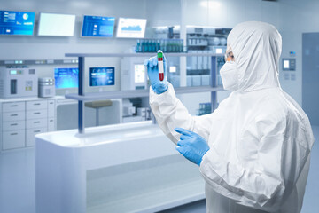 Worker wears medical protective suit or white coverall suit with test tube