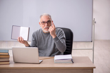 Old male teacher in the classroom