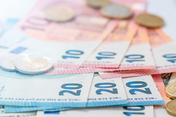 Many Euro banknotes stacked on top of each other.