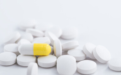 White and yellow medicine tablets antibiotic pills, pharmacy theme.