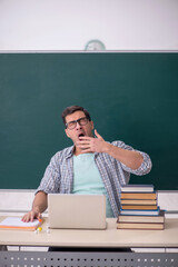 Young male student sitting in the classroom