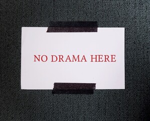 White note stick on wallpaper wall NO DRAMA HERE - concept of to avoid conflicts - eliminate...