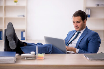 Young male employee working in the office
