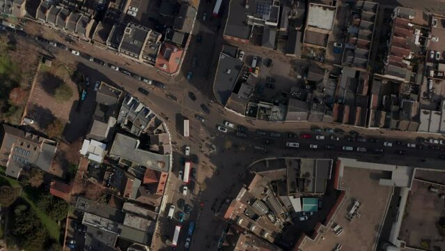 Stationary top down aerial shot over traffic intersection in english town centre