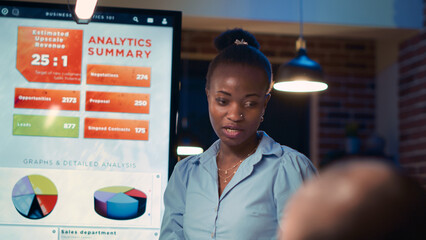 Businesswoman reading report, giving presentation in business meeting, holding clipboard close up. African american employee showing analytics research charts, statistics on digital board