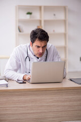 Young male doctor in telemedicine concept