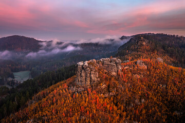 Jetrichovice, Czech Republic - Aerial panoramic view of Bohemian Switzerland National Park with Mariina Vyhlidka (Mary's view) lookout and foggy Czech autumn landscape and colorful pink sunrise sky