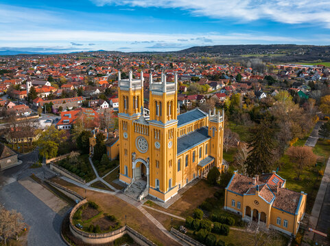 Fot, Hungary - Aerial view of the Roman Catholic Church of the Immaculate Conception (Szeplotlen Fogantatas templom) in the town of Fot on a sunny spring day with blue sky and clouds