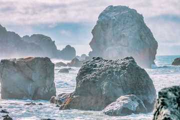 A majestic spectacle of nature, massive rocks rising above the sea surface of the ocean are...