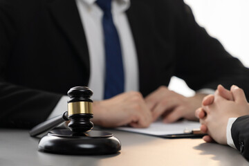 Lawyer colleagues or legal team working or drafting legal document at law firm office desk. Gavel...