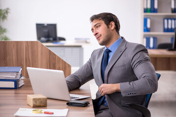 Young male employee working in the office