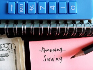 Calculator , Cash dollars money and pencil on note written SHOPPING (cross to SAVING - concept of...