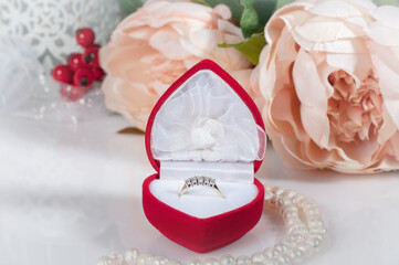 Diamond ring in a red box.