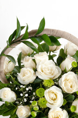 Festive bouquet with white roses in a basket.