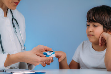 Pulmonology pediatrician measuring blood oxygen levels with pulse oximeter