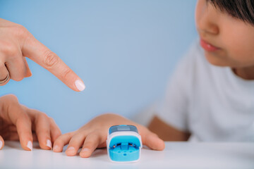Pulmonology pediatrician measuring blood oxygen levels with pulse oximeter