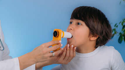 Pulmonologist Measuring Lung Capacity and Force Expiratory Volume to a Boy with Spirometer