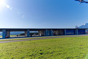 Fototapeta premium Red and white Northrop F-5E Tiger II fighters of Patrouille Suisse at hangar at Swiss Air Force airbase Emmen, Canton Lucerne, on a sunny spring day. Photo taken March 22nd, 2023, Emmen, Switzerland.