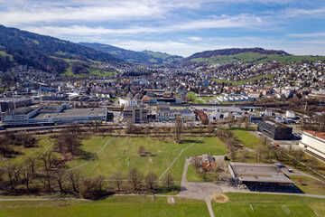 Fototapeta na wymiar Aerial view of City of Luzern with City of Kriens in the background on a blue cloudy spring day. Photo taken March 22nd, 2023, Lucerne, Switzerland.